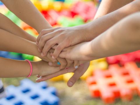 ragazzi che si stringono le mani per evocare il tema delle sfide abitative dei care leavers al centro del capitolo sull'abitare solidale dei care leavers curato da Agevolando all'interno del volume Coabitazioni solidali. Politiche, programmi e progetti 